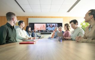 Group in a meeting room with Intellimix Bar Pro