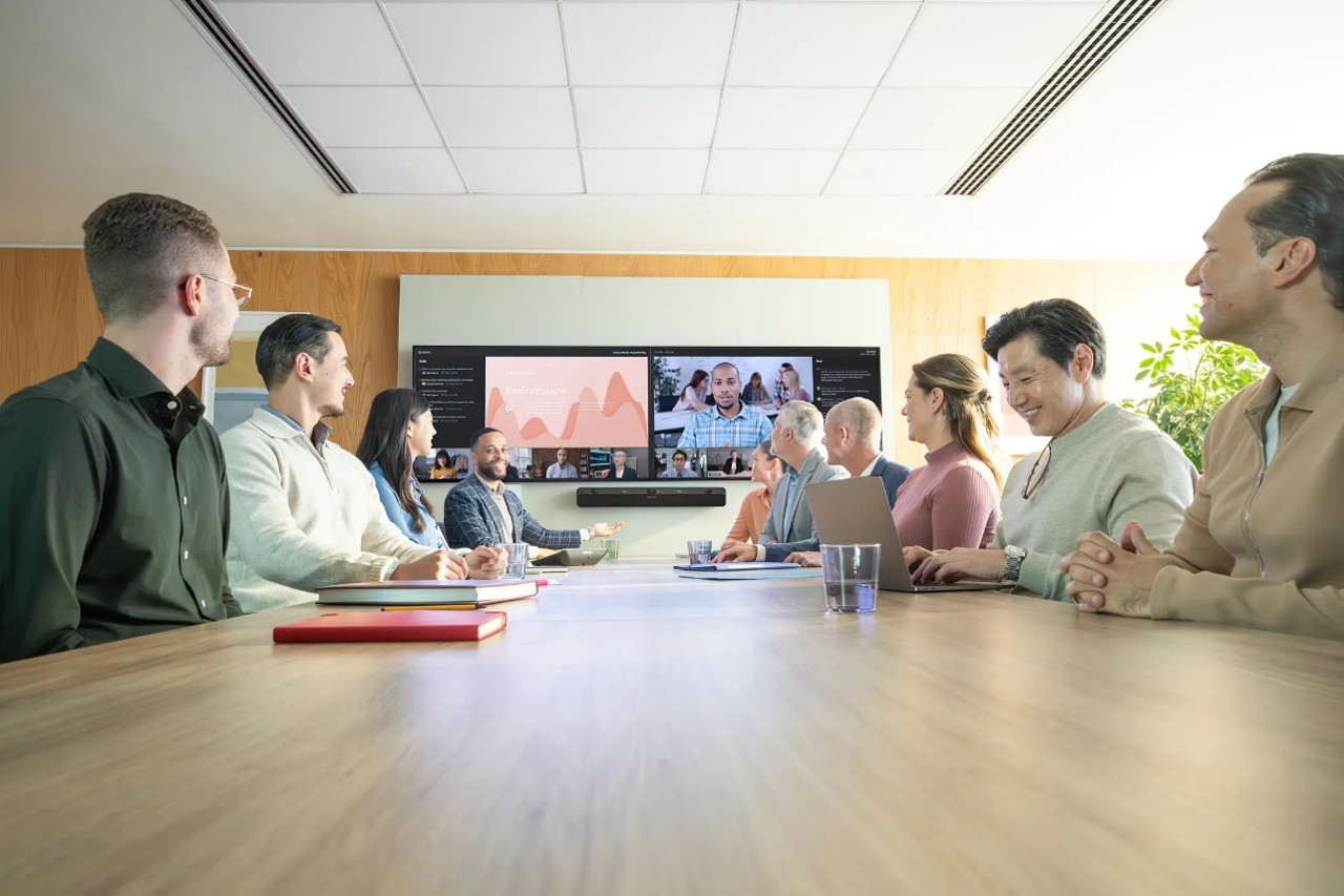 Group in a meeting room with Intellimix Bar Pro
